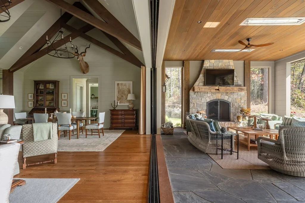 Great room with exposed timber trusses and stone fireplace