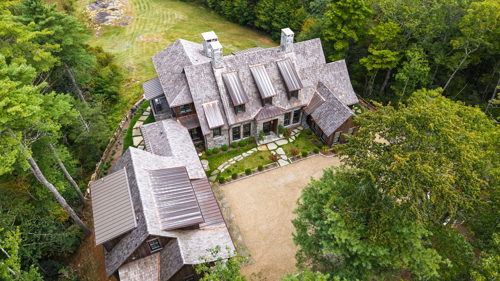 Aerial view of a custom mountain home set in the trees, Western NC