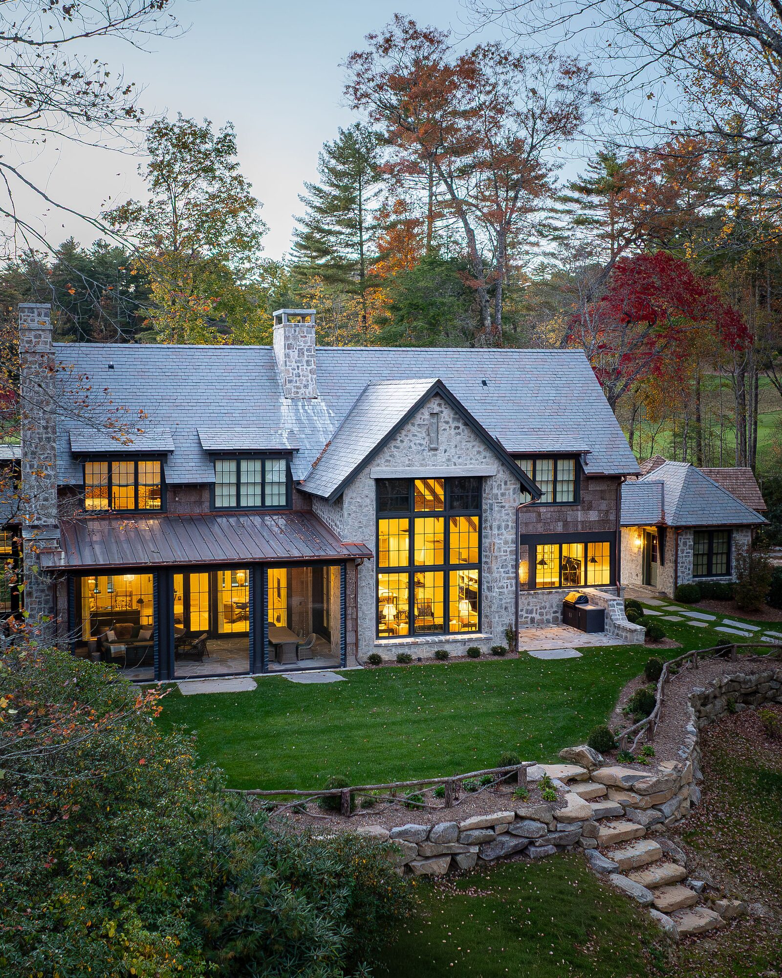 Stone and shingle custom home at dusk from above, High Hampton, Cashiers NC